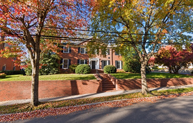 The new Polyad Decision Sciences office at 1004 College Avenue, a two-story red brick building framed by autumn trees